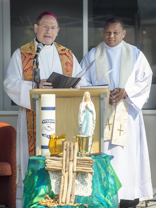 Bishop Anthony blesses the building.