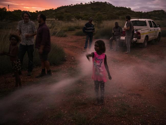 Children, nieces and nephews of Norm Frank Jupururrla play on the block of land where the Wilya Junta (Standing Strong) Housing Collaboration plans to design and build homes. Picture: Andrew Quilty/Climate Council