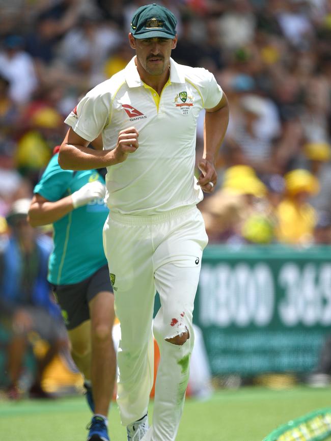 Australian cricketer Mitchell Starc runs from the field with an injury. Picture: AAP.