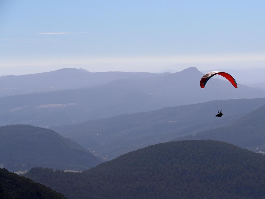 Paragliders gliding at the summit of Mount Wellington with the Derwent Valley in the background. Picture: LUKE BOWDEN