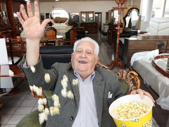 Furniture king Franco Cozzo sits in one of his ornate chairs with a bucket of popcorn. Franco's biopic will screen at the Melbourne International Film Festival.                    Picture: David Caird