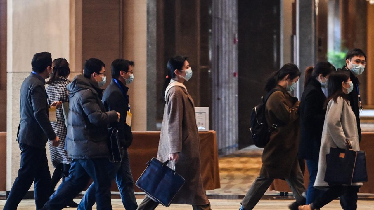 Chinese officials arrive for meetings with the World Health Organisation in Wuhan.