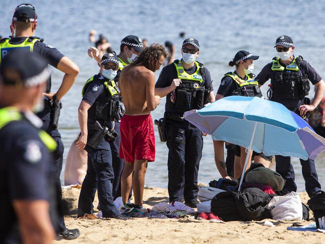 Police speak to a man. Picture: Aaron Francis