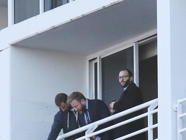 People believed to be police are pictured on the balcony of the room at the Hyatt Regency in Sydney this morning after a woman was found dead last night. Picture: David Swift