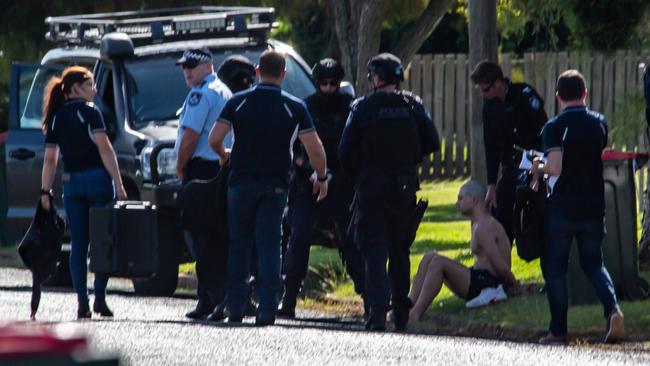 Police take a man into custody after a siege in Doonkuna St, Kingaroy. March 21, 2022. Picture: Dominic Elsome