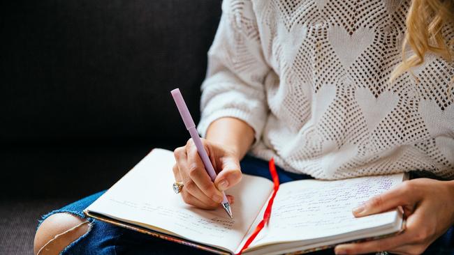 Michelle Menzies. Writing in her journal. For TasWeekend. Supplied.