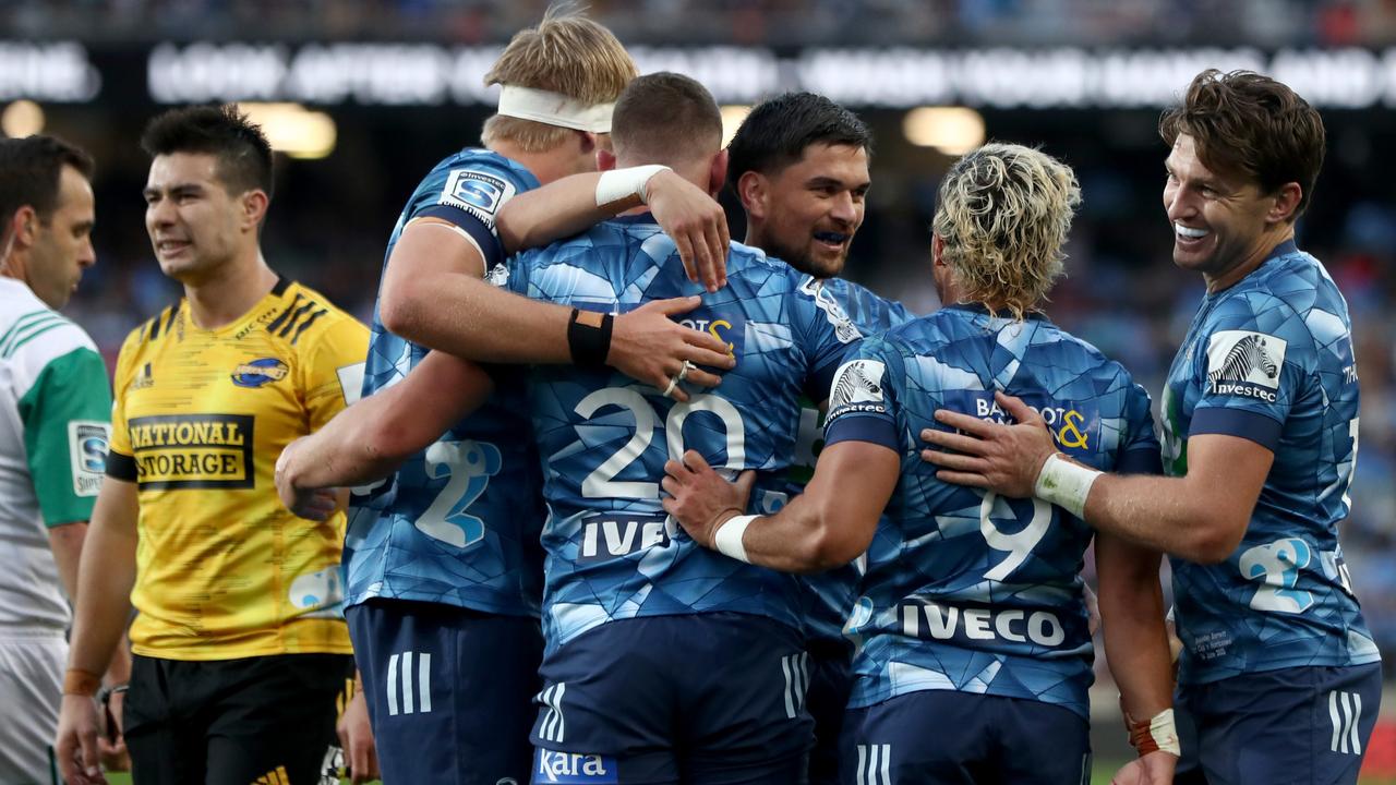 The Blues celebrate a try against the Hurricanes. (Photo by Hannah Peters/Getty Images)