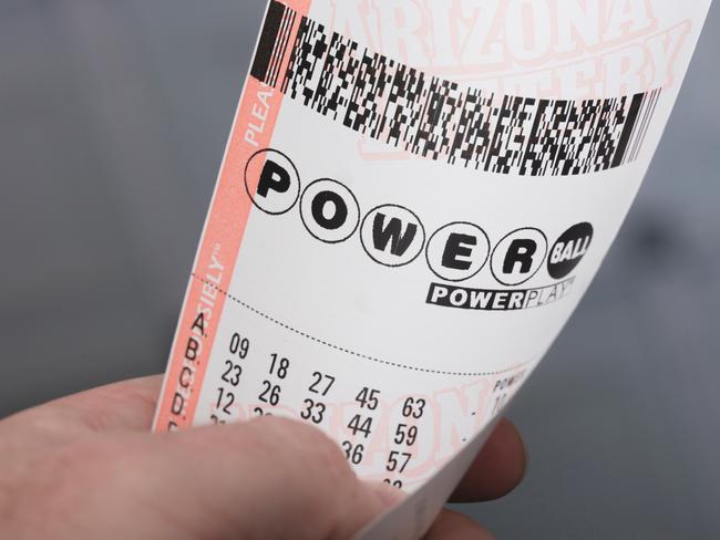 Kingman, USA - January 20, 2016: A photo of a man holding a Powerball lottery ticket in Kingman, Arizona.