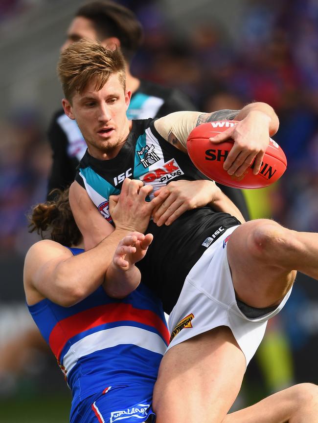 Hamish Hartlett is tackled by Bulldog Marcus Bontempelli in Ballarat on Round 22. Picture: Quinn Rooney/Getty Images