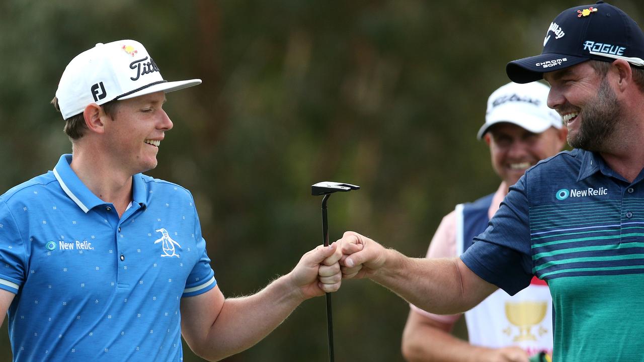 Aussie teammates Cameron Smith and Marc Leishman celebrate a birdie.Y