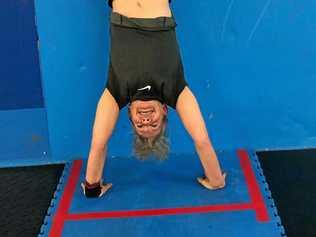 STANDING PROUD: Gold medal winner Helen Brennan does a handstand at CrossFit Kanga. Picture: Cherise Walmsley