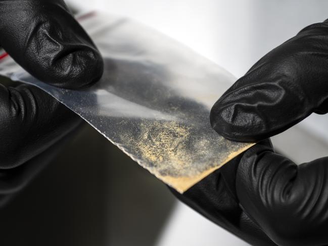 Alex Krotulski, 32, associate director and forensic toxicologist, holds a nitazene powder sample at the Center for Forensic Science Research and Education on Friday, Oct. 20, 2023, in Willow Grove, Pa. Nitazenes are a class of synthetic opioids typically sold as heroin and are estimated to be several times more potent than fentanyl.(Photo by Joe Lamberti for The Washington Post via Getty Images)