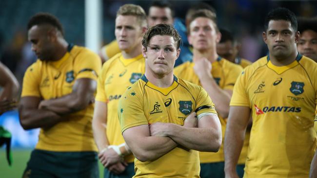 Michael Hooper of Australia stands with his team mates.