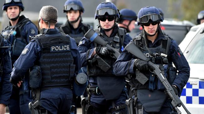 Police in riot gear gather outside the prison. Picture: Jay Town