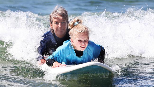 Layne Beachley with Bella Kay 9 of Hobart. Former world champion surfer Layne Beachley at the Women in Waves day at Clifton Beach. Picture: Nikki Davis-Jones