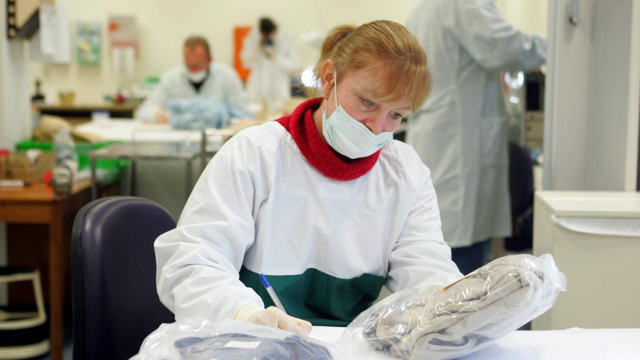 Forensic technician Sharon Wilczek examining clothing recovered from the home of Bevan Spencer von Einem in Paradise, Adelaide.