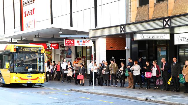 Commuters waiting to catch buses in the city. Picture: Stephen Laffer