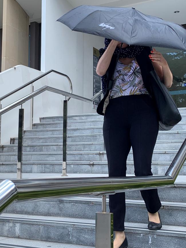 Sarah Longden tried to hide from waiting media as she left the court.