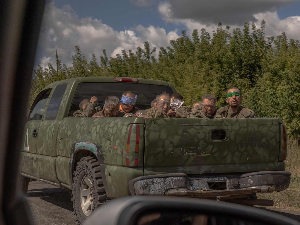 A Ukrainian military vehicle carrying blindfolded men in Russian uniforms. Picture: Roman Pilipey/AFP