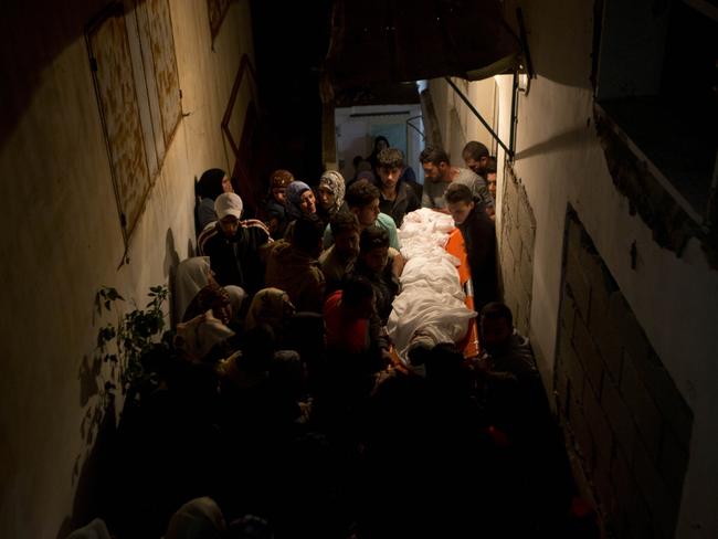 Too young to die ... Palestinians carry the body of Ahmed Ikmel, 16, during his funeral in the West Bank village of Qabatiya. Ikmel was killed after he allegedly attempted to stab an Israeli security guard at a checkpoint near Jenin, according to the police.