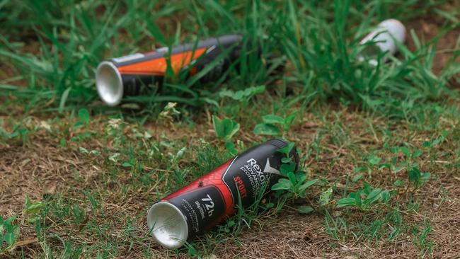 Empty aerosol cans litter a Karama Park in March 2021. Picture Glenn Campbell