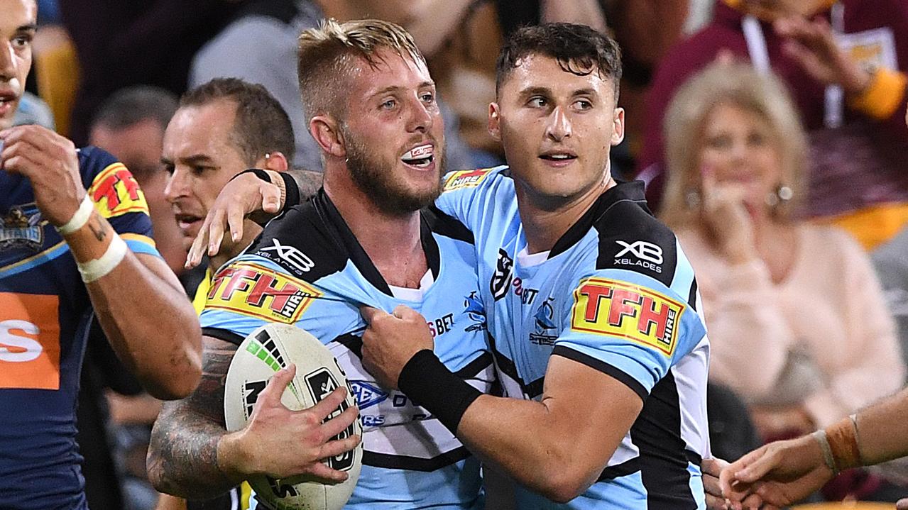 Aaron Gray of the Sharks (left) after scoring his second try against the Titans.