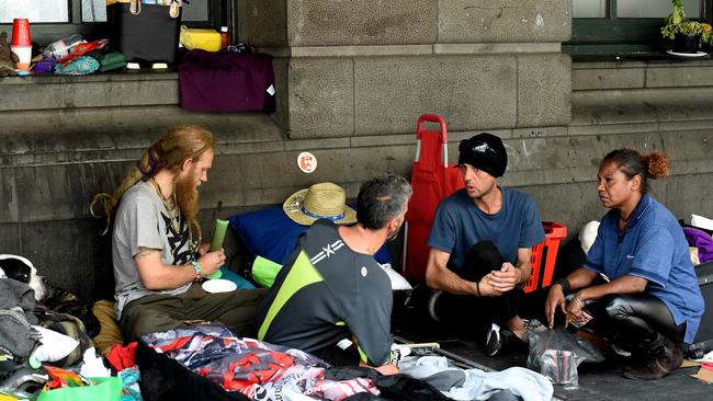 Another man grips the same bong while others chat. Picture: Nicole Garmston