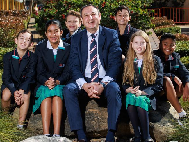 Department of Education secretary Murat Didzar, with Seth Correa, 11; Maahe Chauhan, 12; Stirling Hobb, 12; Zeki Ozturk, 11; Sienna-Rose Kocis, 11; and Kevon Weerapperuma, 12, at John Palmer Public School in The Ponds. Picture: Justin Lloyd.