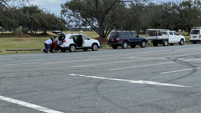 Families unpacking picnic gear on The Spit this afternoon. Picture: Andrew Potts.