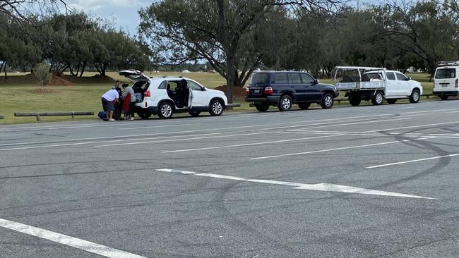 Families unpacking picnic gear on The Spit this afternoon. Picture: Andrew Potts.