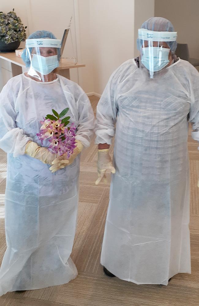 Elena Turner of NSW in full PPE and with flowers at a private viewing of her son's body. Picture: Supplied