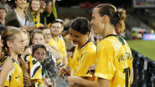 Sam Kerr (centre) and Emily van Egmond enjoy time with some young fans. Picture: Darren Pateman / AAP