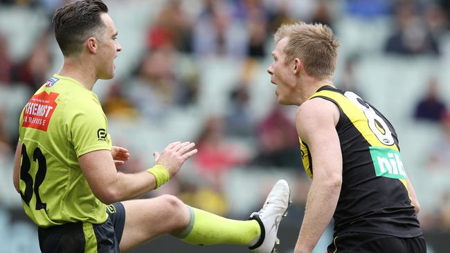 The umpire explains the free kick to Riewoldt. Picture: Michael Klein