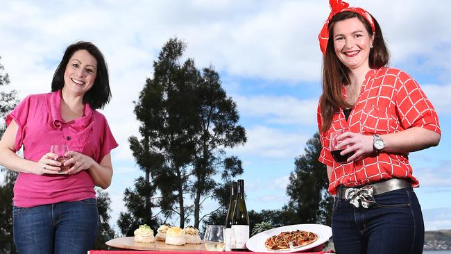 L-R Chantel Crossman with dog Max of Hobart who is a market goer with Jaclyn Schapel stall holder from Domaine Simha who will sell oysters and wine. Food pictured is from stalls PavLovas (PavLovas) and Wood Fiery Redhead Pizza. Hobart Twilight Market at Sandy Bay kicks off again this Friday. Picture Nikki Davis-Jones