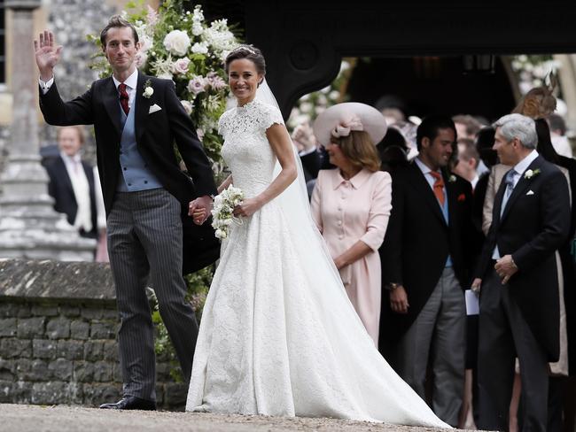 Mr and Mrs Matthews ... Pippa Middleton and James Matthews smile for the cameras after their wedding.