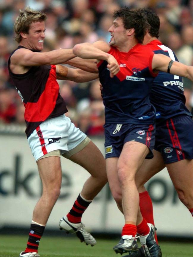 Andrew Welsh clashes with Russell Robertson and Brad Miller during the 2004 elimination final.