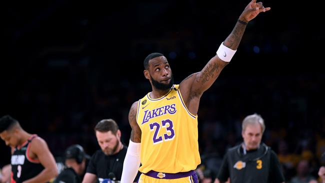 LOS ANGELES, CALIFORNIA - JANUARY 31: LeBron James #23 of the Los Angeles Lakers points at the two retired jerseys in the rafters to honor Kobe Bryant before the game against the Portland Trail Blazers at Staples Center on January 31, 2020 in Los Angeles, California.   Harry How/Getty Images/AFP == FOR NEWSPAPERS, INTERNET, TELCOS & TELEVISION USE ONLY ==