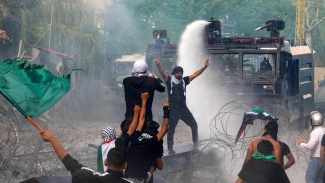 Lebanese security forces use water cannons as they clash with protesters outside the US Embassy in Awkar east of Beirut.