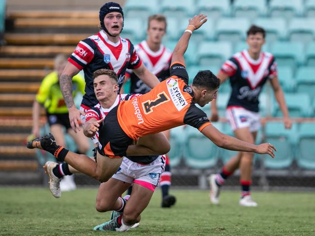 Cameron Kanaan is sent skywards by Roosters player Zac Sarfati. Picture: Julian Andrews