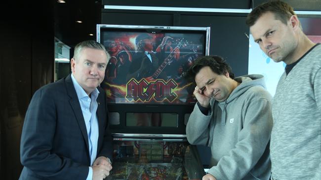 In sadder times ... Eddie McGuire, Mick Molloy and Luke Darcy distraught over Triple M's unplugged pinball machine.