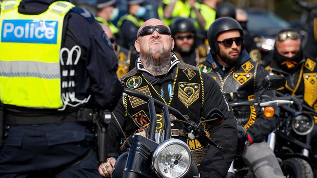 Comanchero Motorcycle Club President Mick Murray with other members as they await to have their identifications checked at the United Petrol Station in Tooradin. Picture: Ian Currie