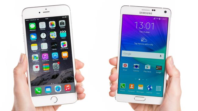 iPhone 6 Plus and white Samsung Galaxy Note 4 hand-held by woman