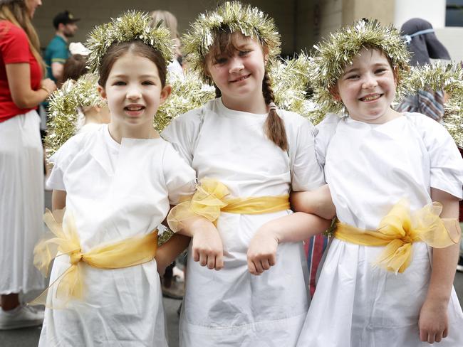 Evelyn Paine 7, Evelyn Cowie 7, Ashlee Hewitt 7 all dressed as angles from the Holy Rosary Catholic School float. Hobart Christmas Pageant 2024. Picture: Nikki Davis-Jones
