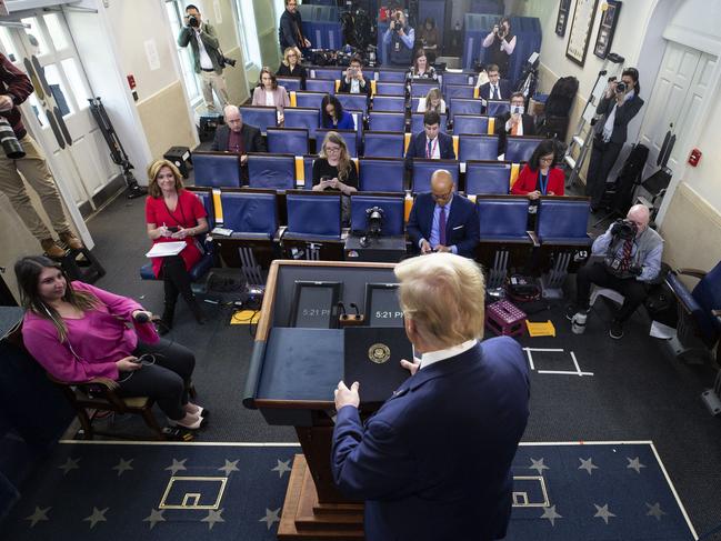 Journalists keep their distance in the James Brady Press Briefing Room at the White House, in Washington, as the US President gives his address. Picture: AP