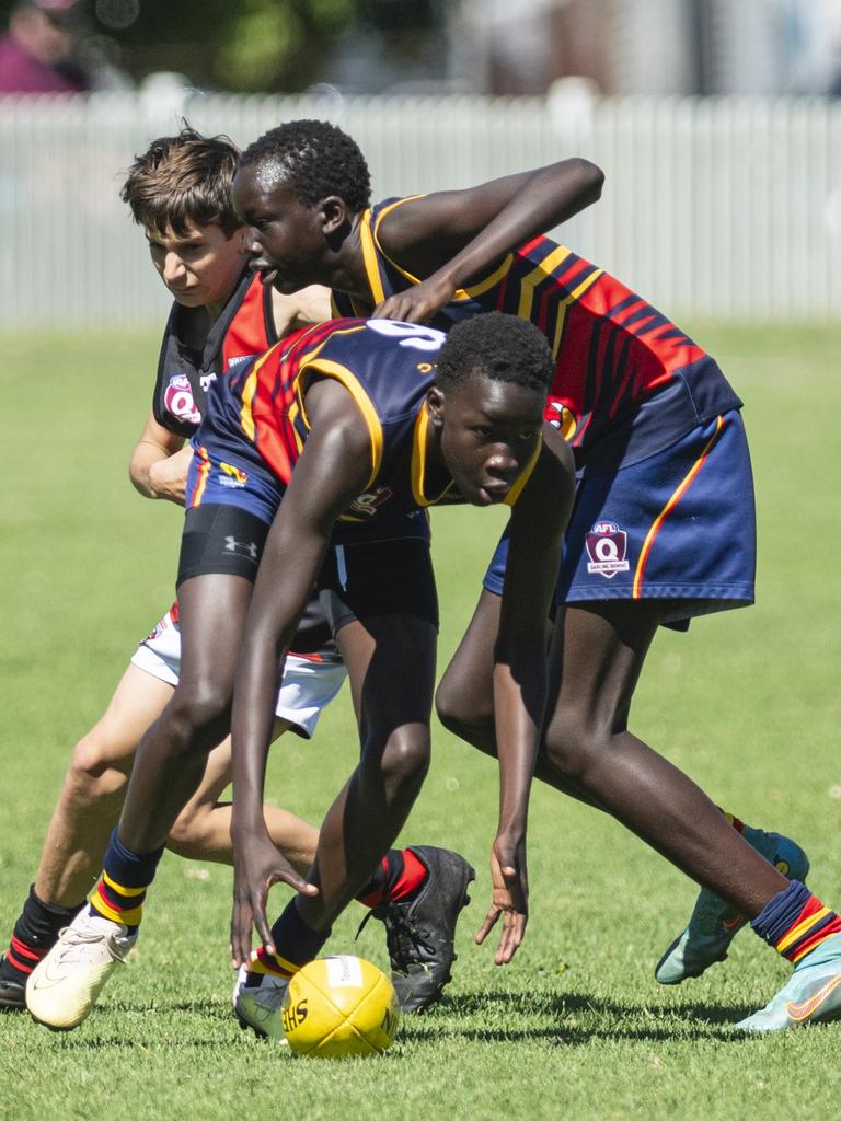 Moses Amreis gets possession for University Cougars against South Toowoomba Bombers in AFL Darling Downs under-14 mixed grand final. Picture: Kevin Farmer