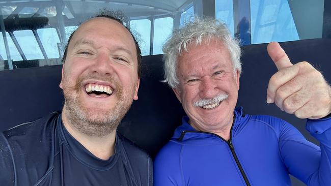 Nicholas Meyer with his father, Adrian Meyer aboard the Reef Experience tour boat near Cairns on Monday, November 20, 2023.