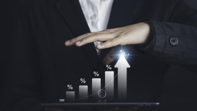 l businessman calculating investment income on a tablet with percentage symbol and up arrow, Interest rates continue to increase, return on stocks compound interest generic