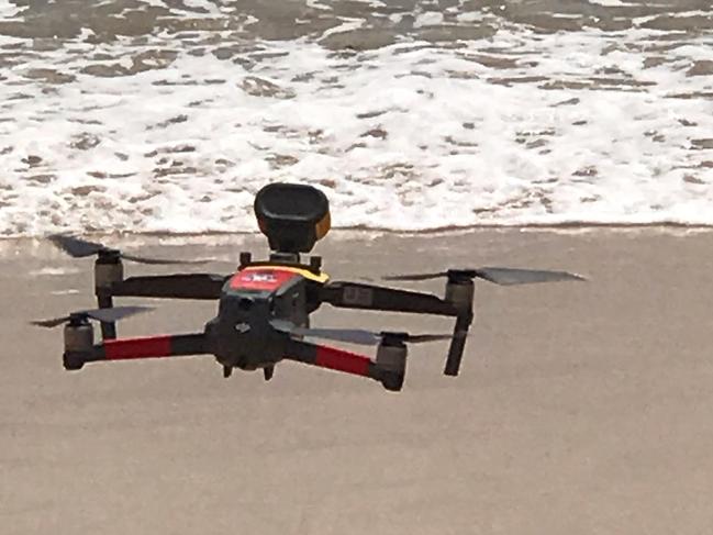 A drone, with video camera attached, in flight at the launch at Manly Beach of the joint Surf Life Saving NSW/Northern Beaches Council initiative to keep beaches and parks COVID-Safe this summer. Picture: Northern Beaches Council