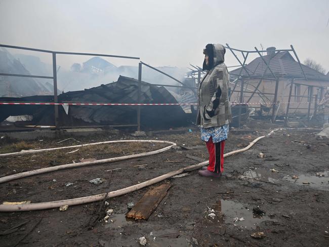 A local resident reacts as she looks at her neighbours' house, which was destroyed in a drone strike in Kharkiv, on December 25, 2024. Picture: AFP