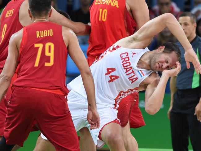 Croatia’s shooting guard Bojan Bogdanovic falls after being injured during a Men’s round Group B basketball match between Croatia and Spain